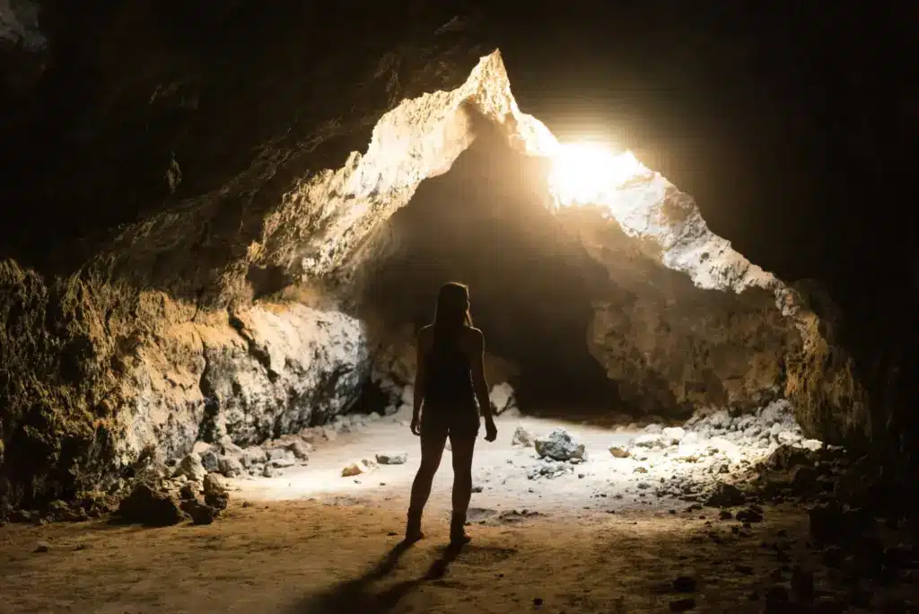 Photo of a woman standing in a cave