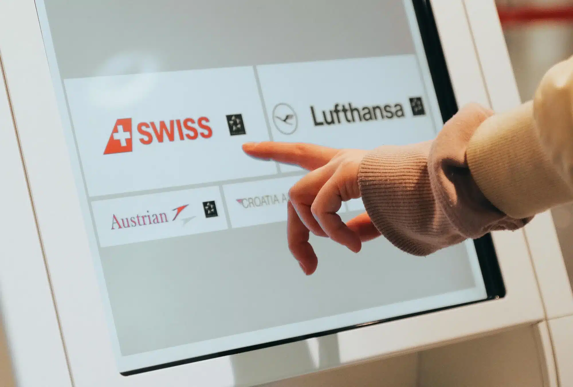 Web design for digital touchscreen kiosks: Image of someone using one