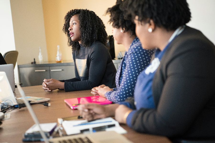 Women consulting around a boardroom table